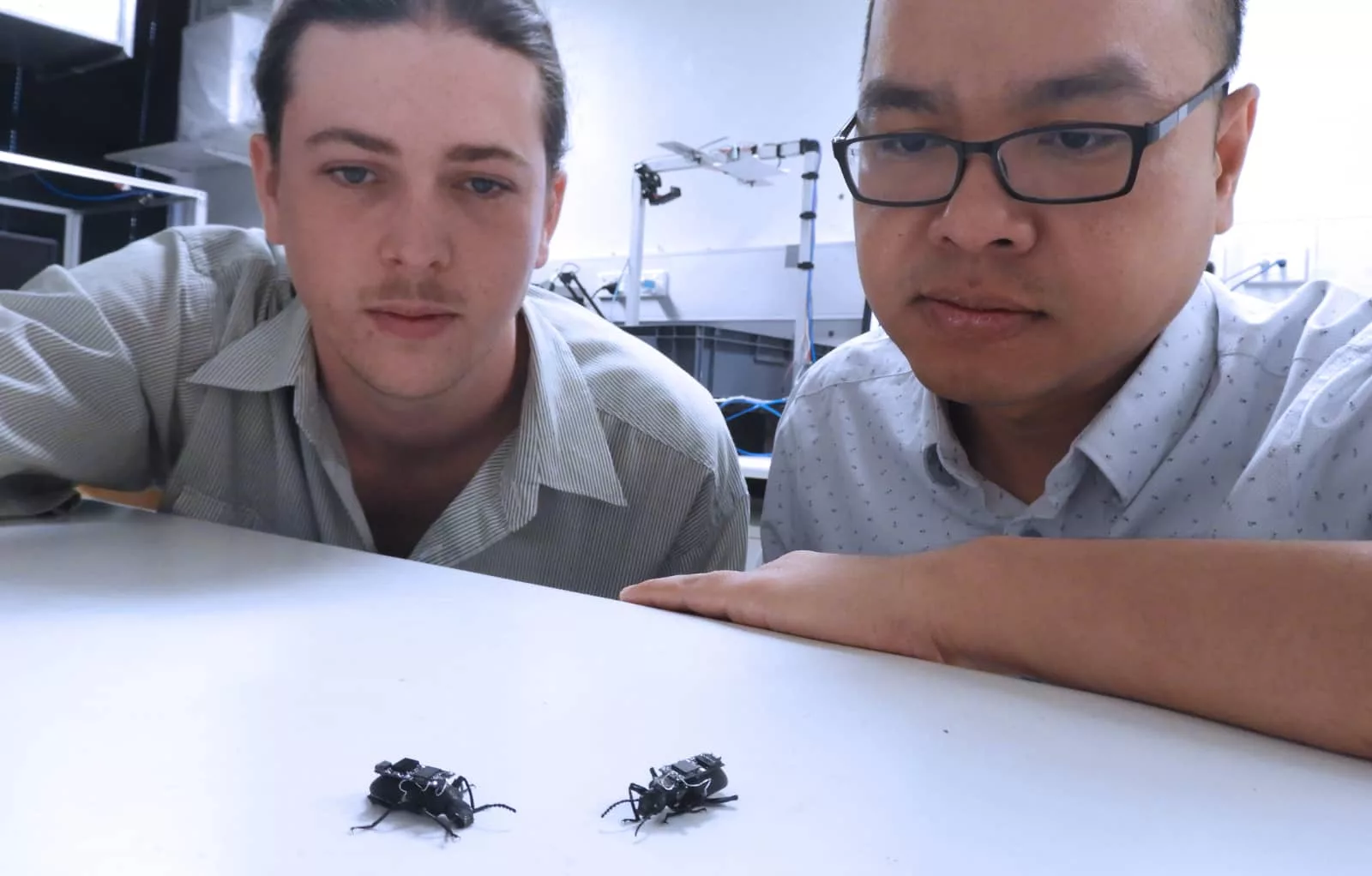 Research Assistant Lachlan Fitzgerald (left) and Dr Thang Vo-Doan (right) with their cyborg beetles.